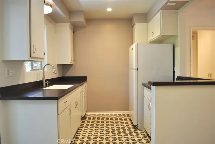 Kitchen with white cabinets and gorgeous hand painted tiles