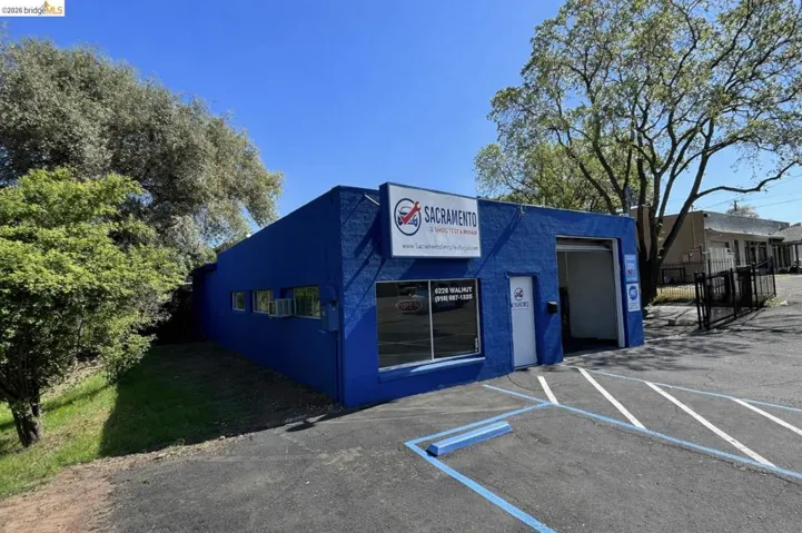 View of commercial location featuring uncovered parking
