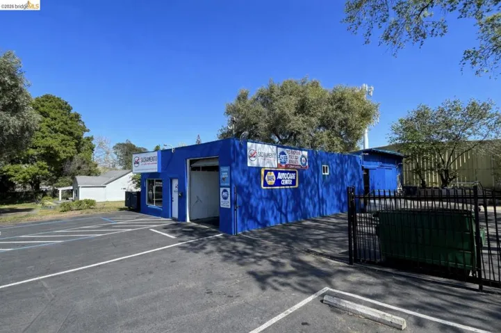 View of commercial property featuring uncovered parking