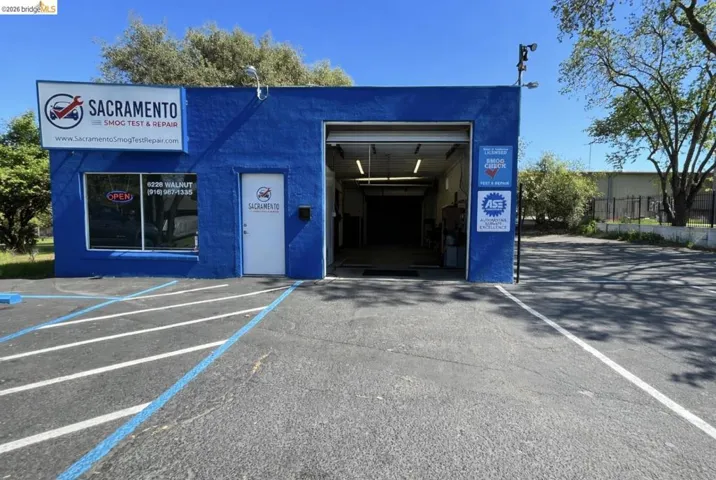 View of commercial location featuring uncovered parking