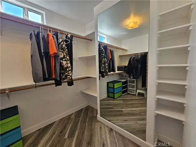 Master Bledroom walk-in closet with built-in mirror and shelvings for easy organization.