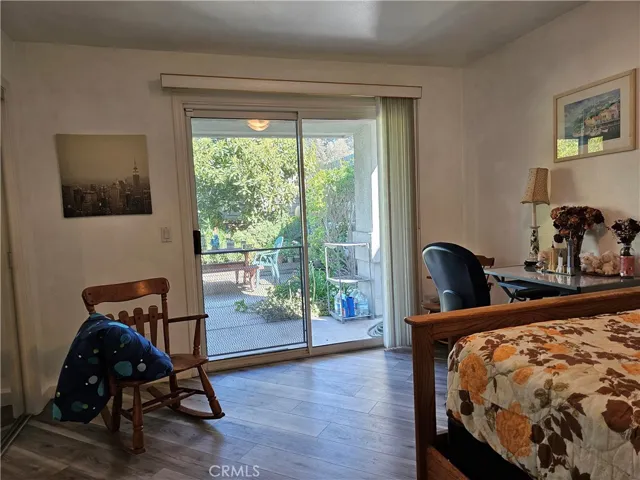 Spacious 2nd bedroom located on 1st floor with access to patio garden w/mirrored closet doors.