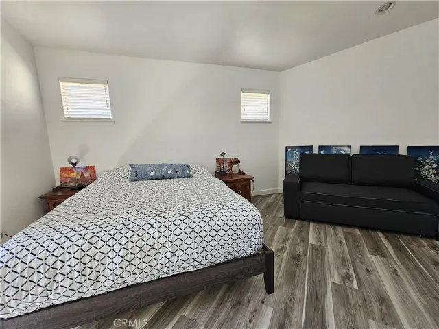 A spacious master bedroom with room for a sofa and dresser, blending comfort and functionality