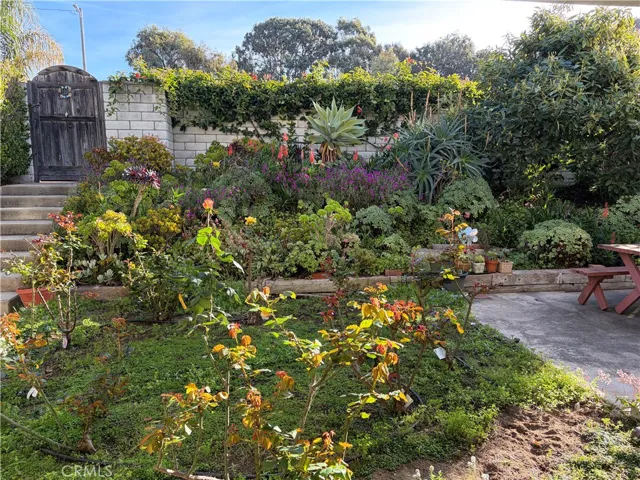 A gated entrance opens to a stunning, lush garden creating a private, secret-garden ambiance, tranquility and serene beauty.