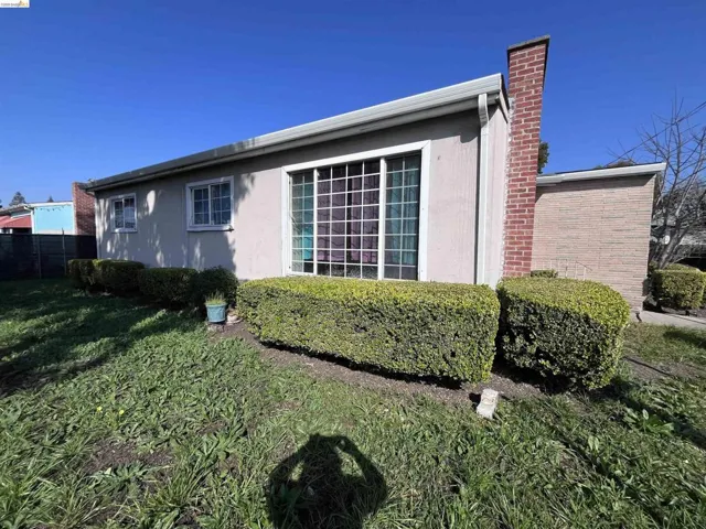 View of home's exterior with a chimney and stucco siding
