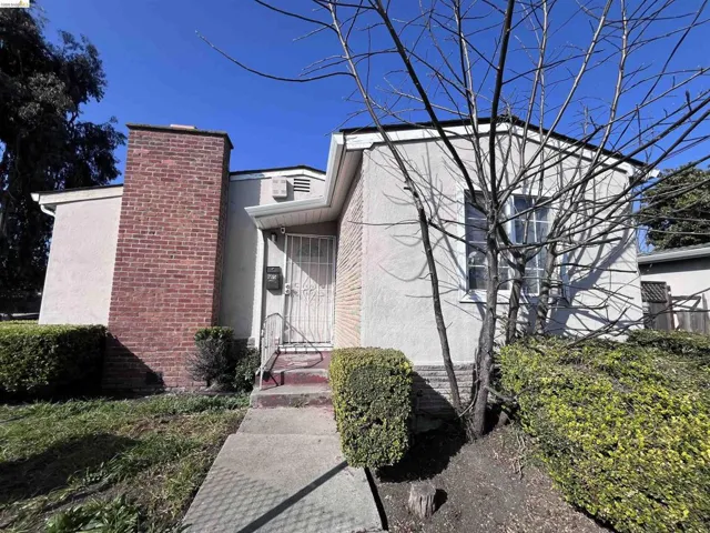 View of front of property with stucco siding and a chimney