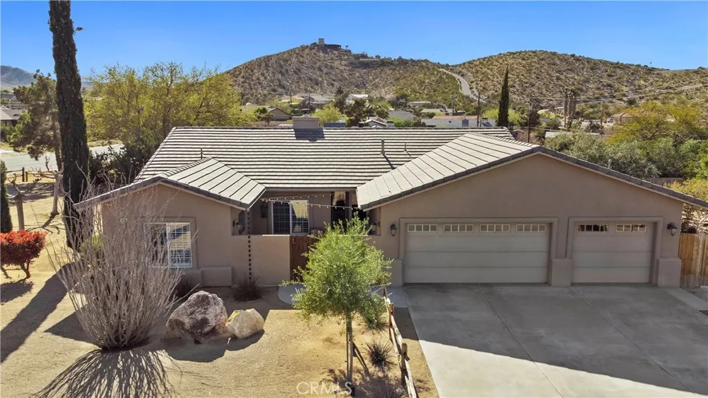 Clean and beautifully manicured property. 3 car garage, concrete driveway.