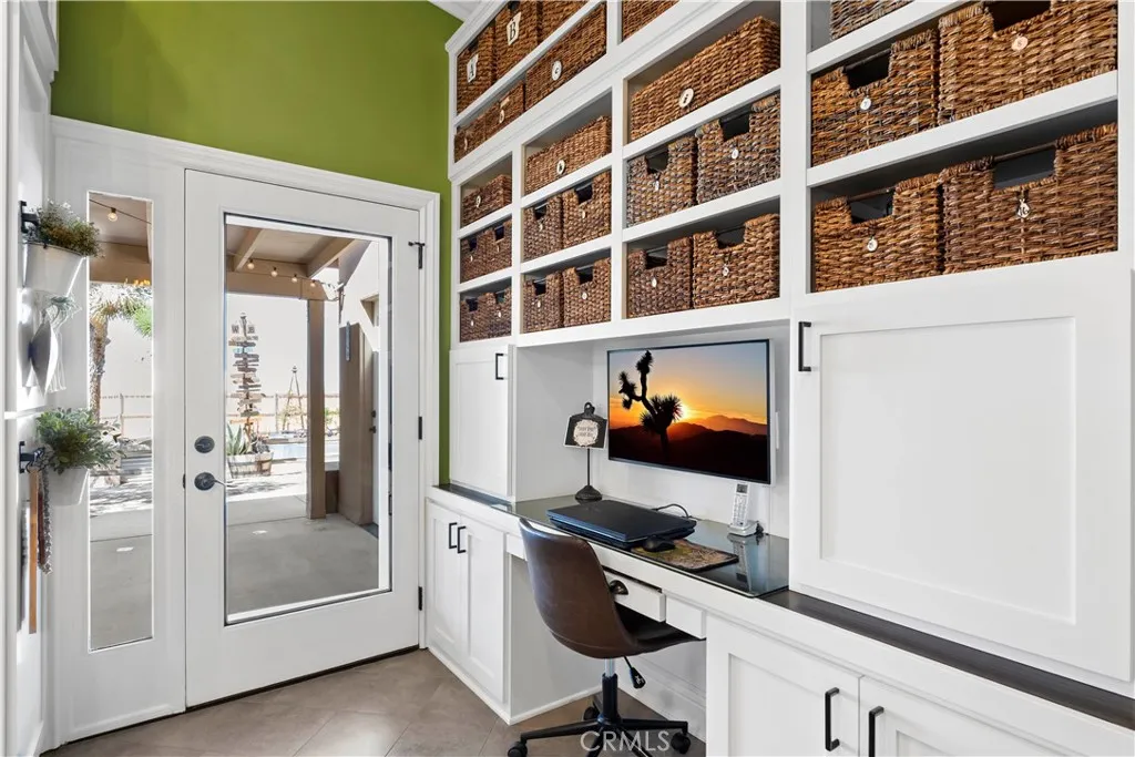 Custom built desk, adjustable shelves. Double doors to side covered patio and BBQ area.