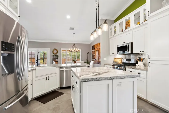 Shaker style cabinets, with lighted upper glass faced cabinets.