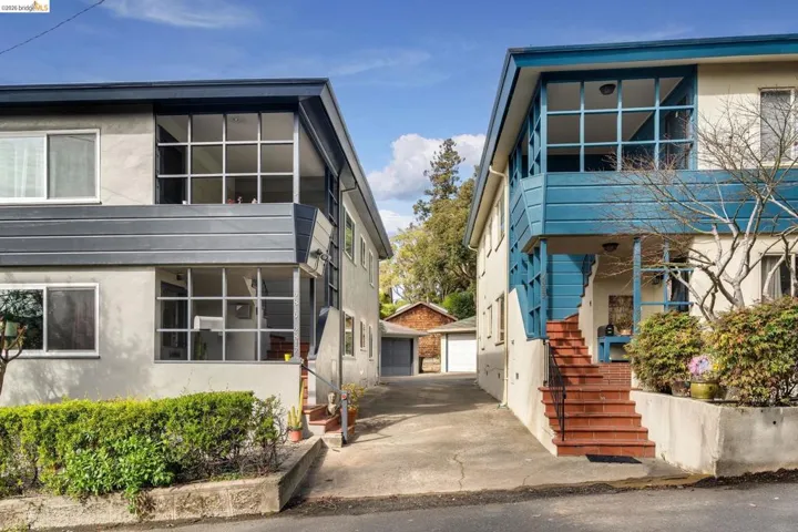 View of front of house featuring an outbuilding, a garage, and stucco siding