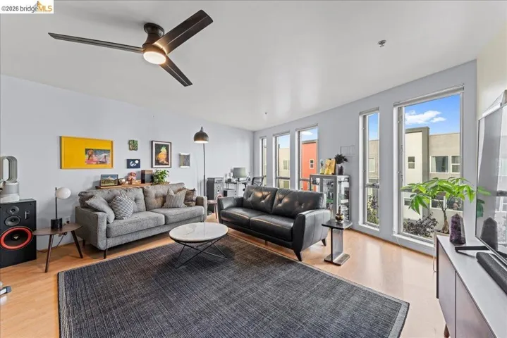 Living area featuring light wood finished floors and ceiling fan