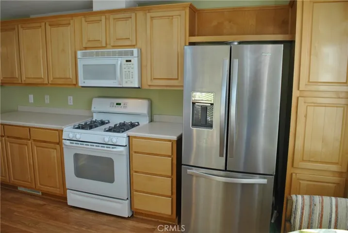 Beautiful chrome fridge, floor to ceiling pantry builtin to the right