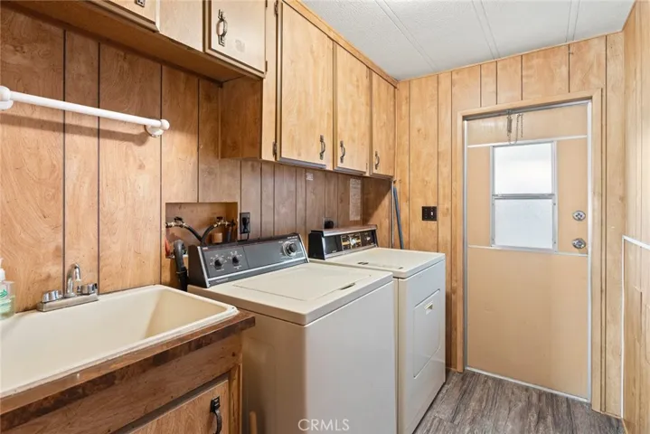 Laundry room with utility sink and back door to carport