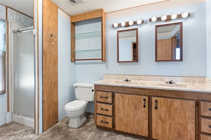 Primary bathroom with dual sinks and walk in shower
