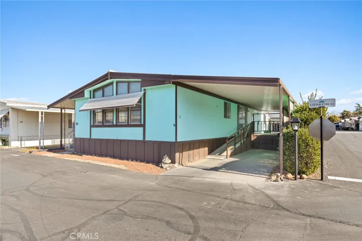 Front of home and carport with ramp to the back door