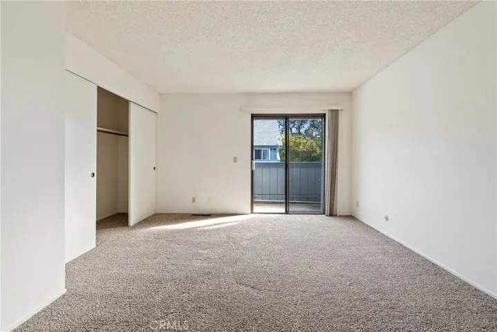 The primary bedroom offers a large closet and private balcony.