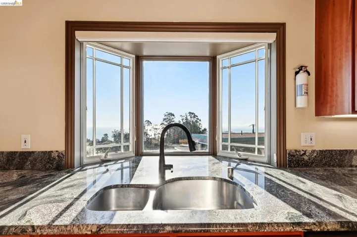 Kitchen view of dark stone counters
