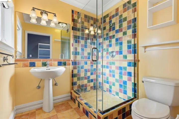Bathroom featuring a stall shower and decorative backsplash