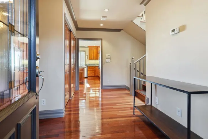 Hallway with light wood finished floors and recessed lighting