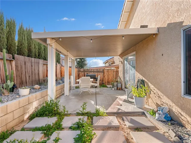 Full-length patio cover provides shade and comfort — perfect for summer BBQs and evening gatherings.