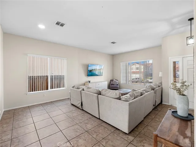 Large front-facing windows provide natural light and neighborhood views.