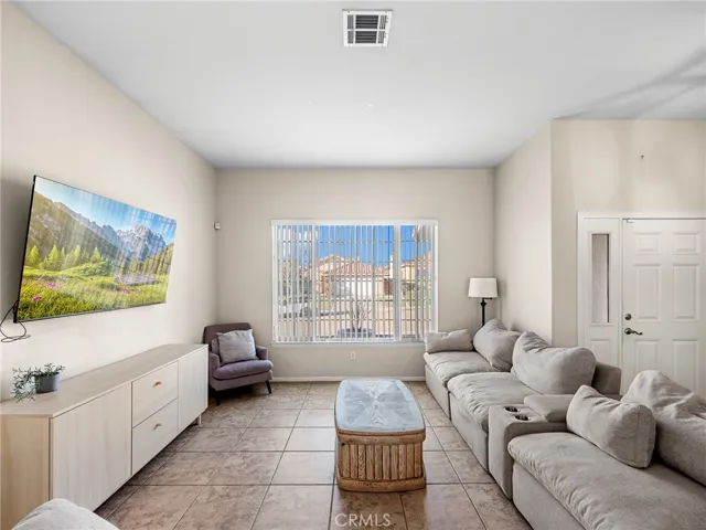 Bright entry with tile flooring and high ceilings creating an open, welcoming feel.