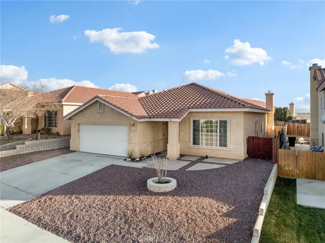 Inviting covered front porch entry with stucco columns and welcoming curb appeal.