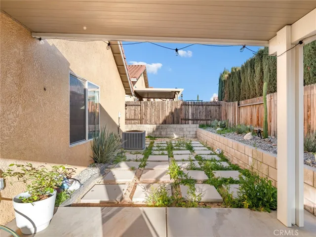 Private yard with block retaining wall, drought-tolerant landscaping, and plenty of room to personalize.