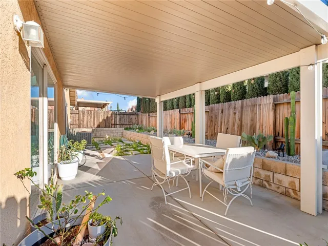 Full-length patio cover provides shade and comfort — perfect for summer BBQs and evening gatherings.