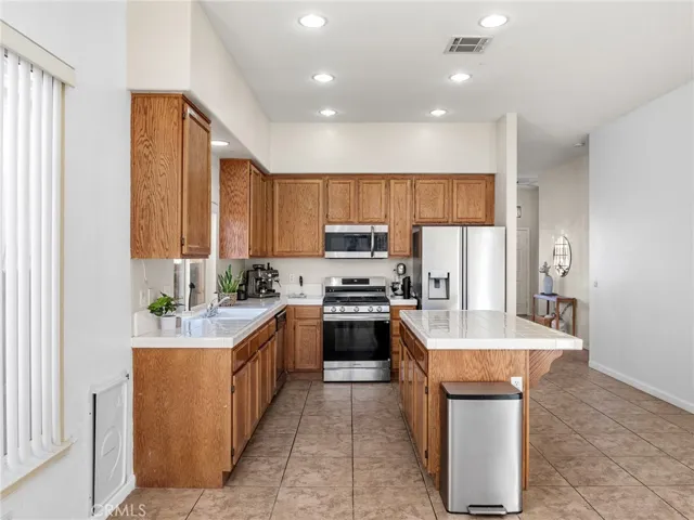Functional layout with plenty of prep space, recessed lighting, and direct sightline to family room.