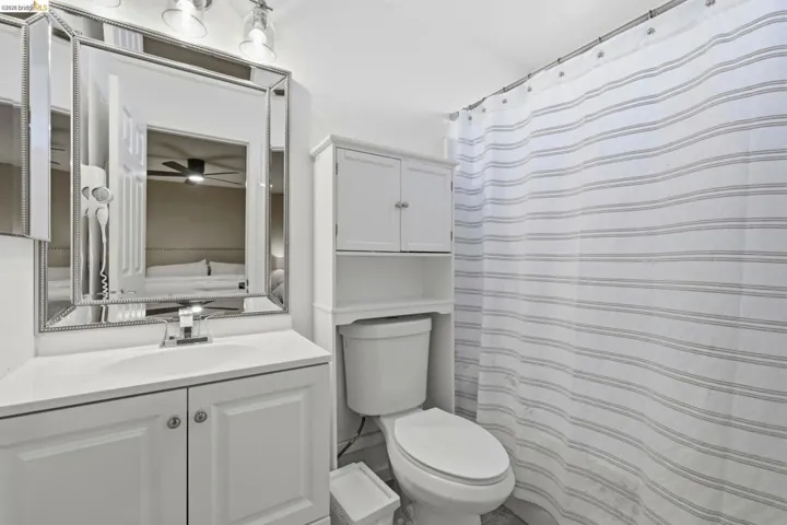 Bathroom featuring a shower with curtain and vanity
