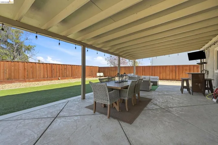 Fenced backyard featuring an outdoor living / dining area and a patio