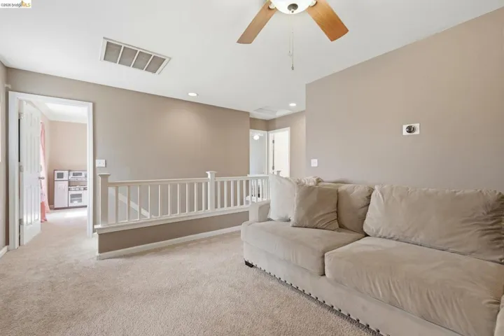 Loft area with a ceiling fan, carpet floors, and recessed lighting