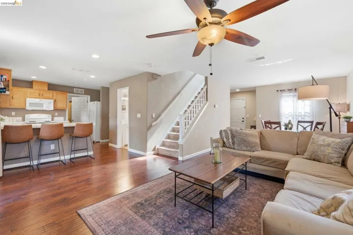 Living area featuring recessed lighting, dark wood finished floors, and a ceiling fan