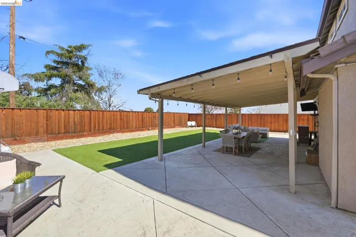 Fenced backyard with a patio area and an outdoor living / dining area