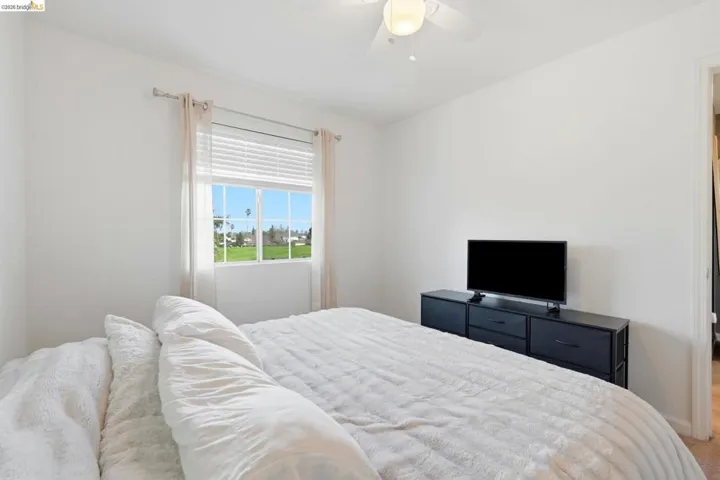 Bedroom with a ceiling fan and carpet flooring