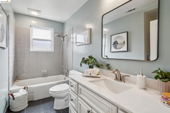 Bathroom with vanity and bathtub / shower combination