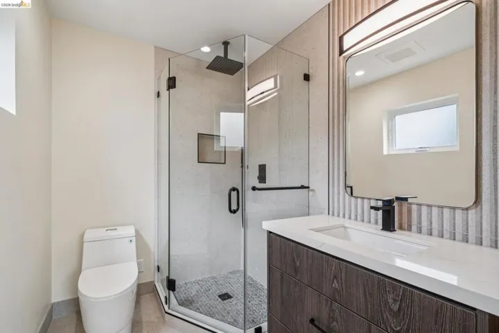 Full bath with vanity and a marble finish shower