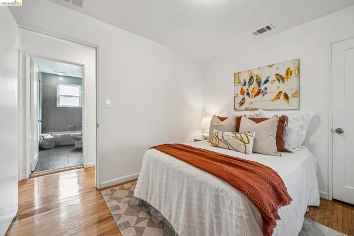 Bedroom featuring light wood-type flooring and baseboards