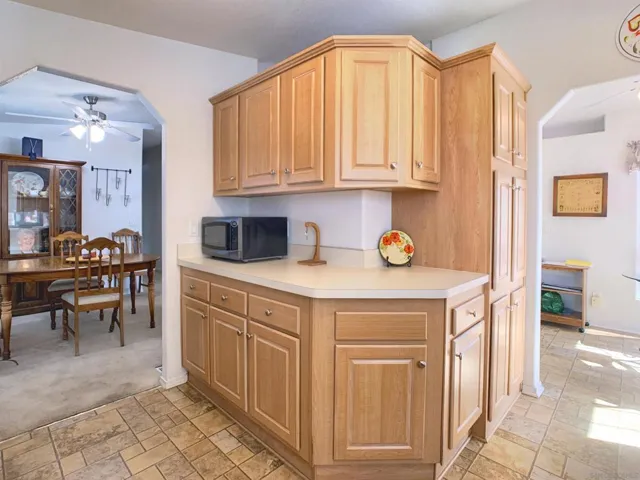 This kitchen is "L" Shaped with plenty of upper and lower cabinetry.