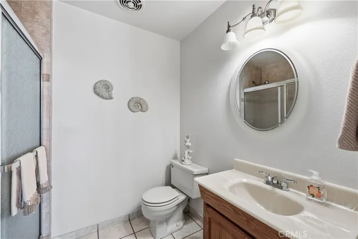 Hallway bathroom, with tile walk-in shower.