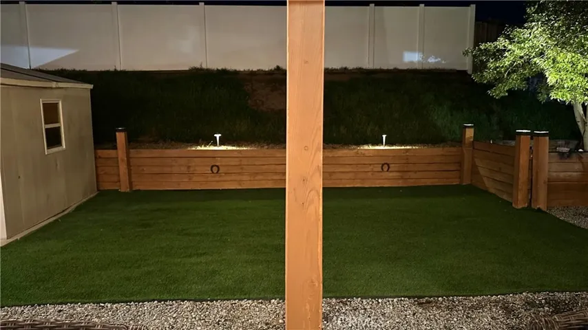 Open space with turf behind the freestanding patio