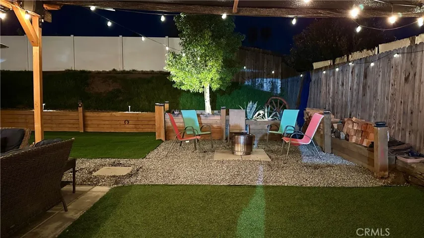 This corner in the backyard has been turned into a cozy fire pit retreat