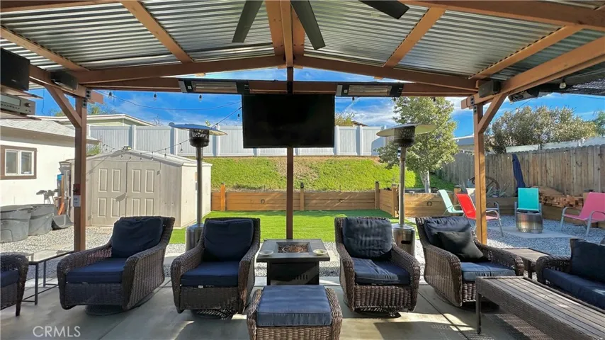 view of backyard from underneath the patio
