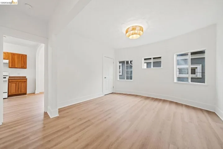unfurnished room featuring light wood-style flooring and baseboards
