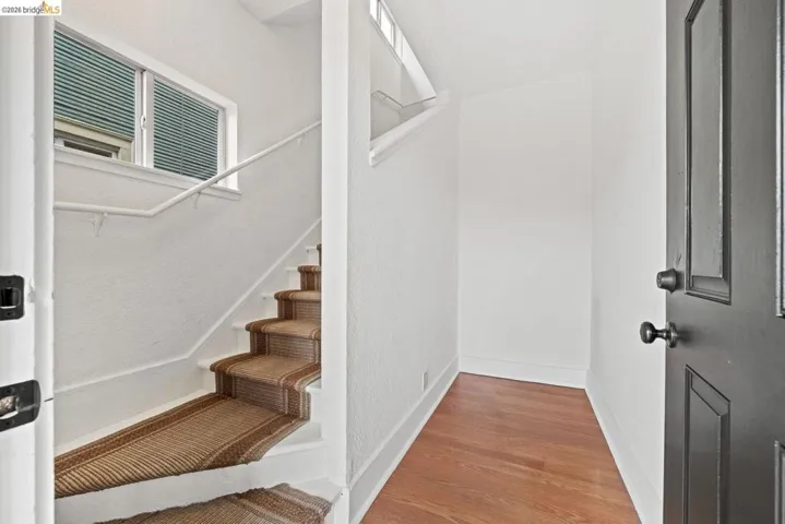 staircase with wood finished floors and baseboards