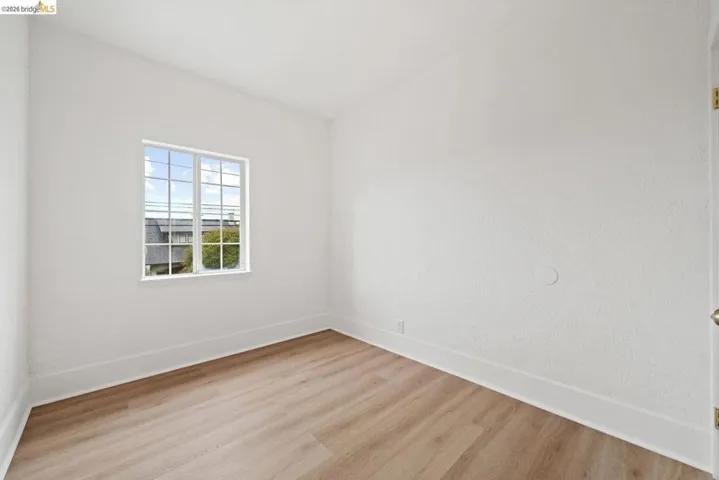 spare room featuring wood finished floors and baseboards