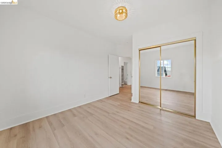 unfurnished bedroom featuring light wood finished floors and a closet