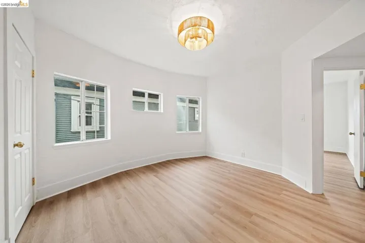 unfurnished room featuring light wood-style flooring and baseboards