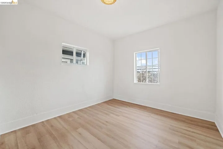 empty room with baseboards and wood finished floors